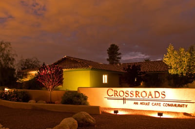 Exterior view of Crossroads Assisted Living at night