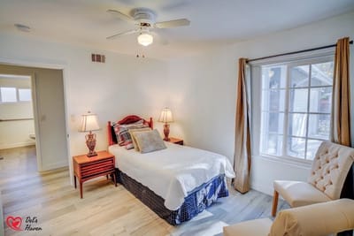 Cozy interior of a private resident room with bed and chair