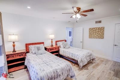 Cozy guest room with twin beds and wooden furniture