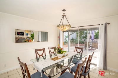 Bright dining area with a glass table and outdoor view