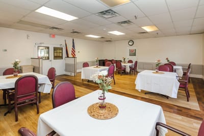 Bright dining room with tables set for meals