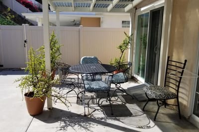 Outdoor seating area with plants and a table