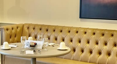 Dining area with plush seating and table setting