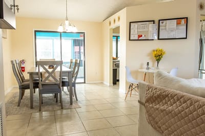 Bright common area with dining table and chairs