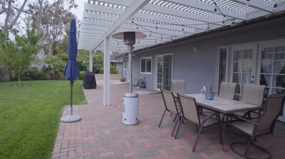Outdoor patio area with seating and heat lamp