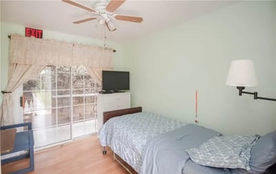 Private resident room with a bed and TV