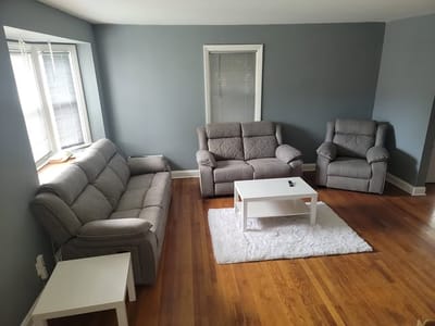 Cozy lounge area with gray sofas and wooden flooring