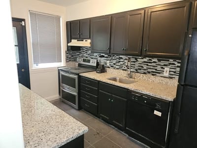 A modern kitchen layout with granite countertops