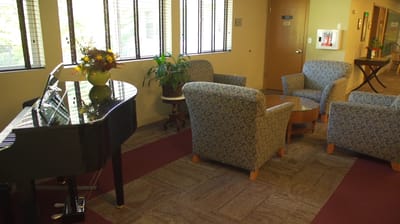 Interior common area with seating and piano