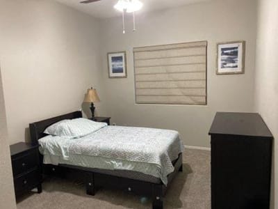 Cozy private bedroom with a bed and nightstand