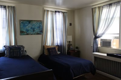 A shared resident bedroom with two beds and decor