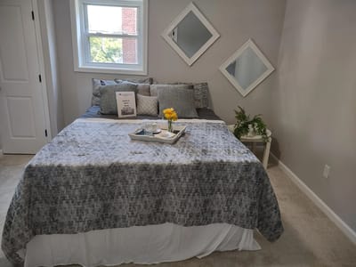 Cozy resident room with decorated bed and flowers