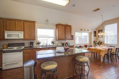 Bright kitchen area with wooden cabinets and table