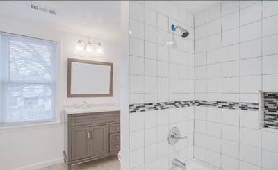 Modern bathroom with tiled shower and vanity