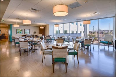 Bright dining area with tables and chairs set up