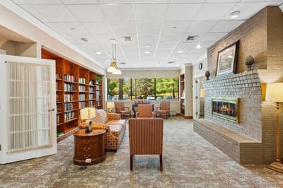 Interior view of a cozy common area with seating and a fireplace
