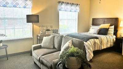 Cozy private resident room with a sofa and bed