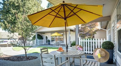 Outdoor patio with yellow umbrella and furniture
