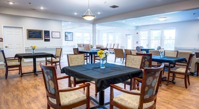 Bright dining room with tables and flowers