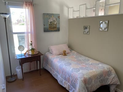 Cozy private resident room with bed and decor