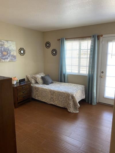 Cozy private resident room with a bed and window