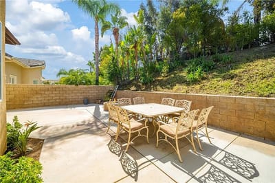 Outdoor patio area with seating and greenery