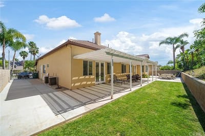 Outdoor patio area with seating and greenery