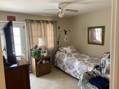 Bright, cozy resident room with bed and amenities