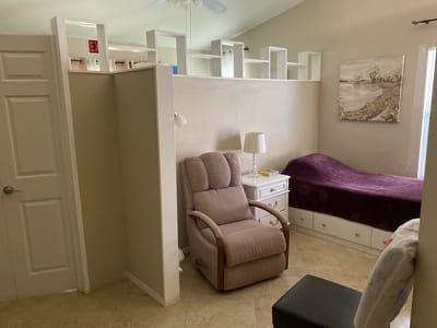Cozy private room with a bed and living area