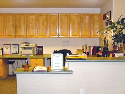 Reception area with wooden cabinets and office supplies