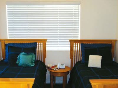 A shared room with two beds and a window