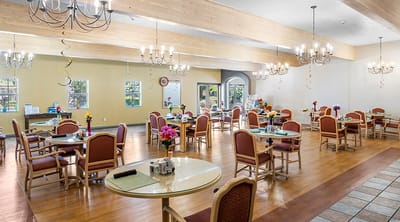 Bright dining area with tables and flowers