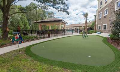Outdoor putting green with shaded sitting area