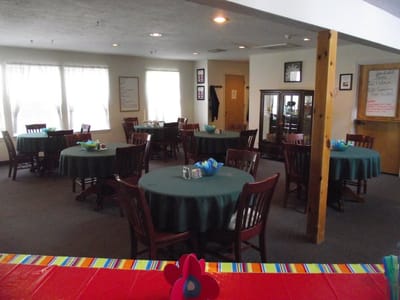 Dining area with tables and chairs set for meals