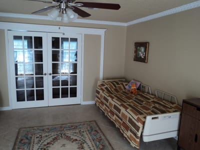 Interior view of a resident room with a bed and decor
