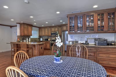 Interior dining area with a table and kitchen in background