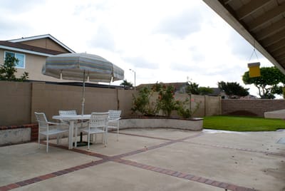 Outdoor patio area with seating and greenery
