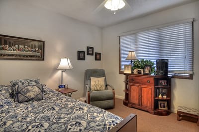 Cozy resident room with a bed and armchair