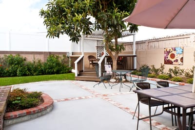 Outdoor patio area with seating and greenery