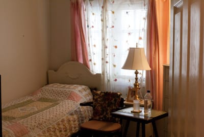 Cozy resident room with a bed and lamp