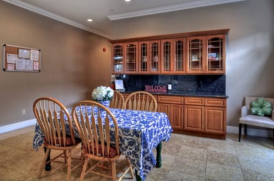 Bright common area with dining table and cabinet