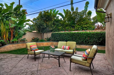 Outdoor seating area with plants and greenery