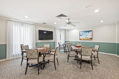 Bright activity room with tables and chairs