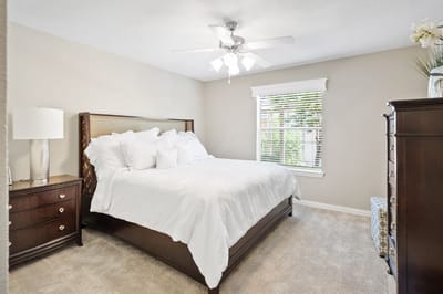 A well-furnished private bedroom in a senior living facility
