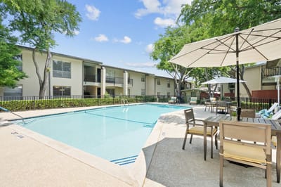 Swimming pool area with outdoor seating and shade