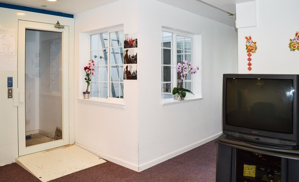 Bright common area with windows and flowers