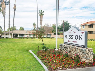 Exterior view of Mission Care Center with landscaped grounds