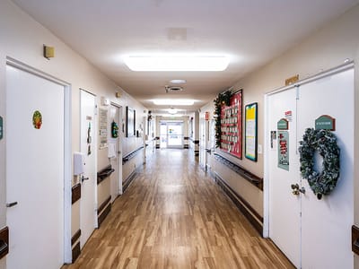 Interior view of a hallway with doors and holiday decorations