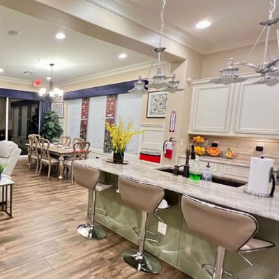 Interior view of a common area with a kitchen and dining table