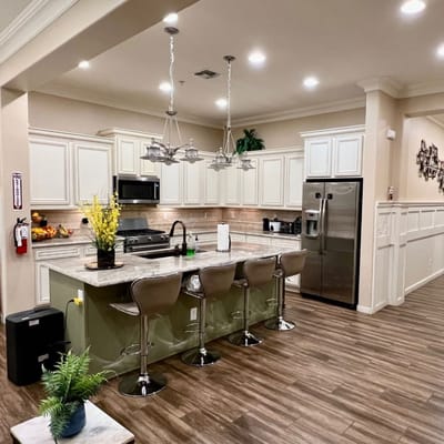 Modern kitchen area with bar seating and appliances